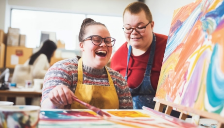 Adult_Students_with_down_Syndrome_Enjoying_an_Art_Class,_Creating_Vibrant_Paintings_with_Laughter.jpg